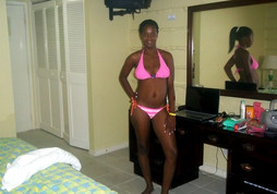 Young African girl in a pink bikini..